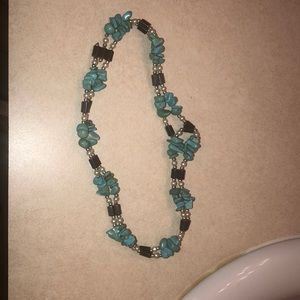 A teal magnet bracelet or necklace.